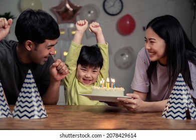 Happy Asian Family celebrating a birthday together at home. Asian little boy blowing candles for his birthday cake with his parents. Happy small Asian family urban lifestyle concept. - Powered by Shutterstock