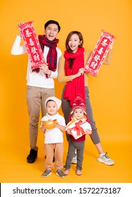 Happy Asian Family Celebrating  Chinese New Year. Chinese Text : Congratulation And  Get Rich