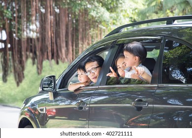 Happy Asian Family Enjoy And Do Activity Together In Car