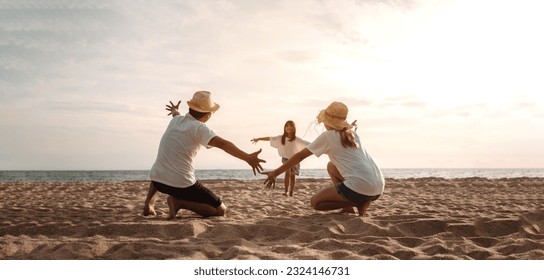 Happy asian family enjoy the sea beach. father, mother and daughter having fun playing beach in summer vacation on the ocean beach. Happy family with vacation time lifestyle concept. - Powered by Shutterstock