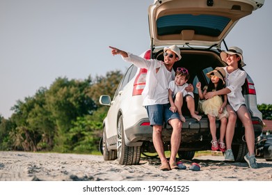Happy asian family enjoying road trip with their favorite car. Parents and children are traveling the way to the sea or ocean.Holiday and travel family concept, Summer vacations. - Shutterstock ID 1907461525