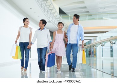 Happy Asian Family Enjoying Shopping On Weekend