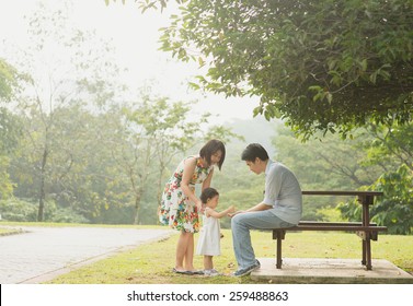 Happy Asian Family Enjoying Their Time In The Park