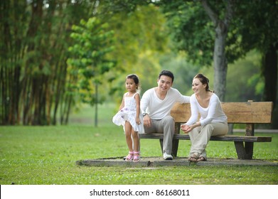 Happy Asian Family Enjoying Their Time In The Park