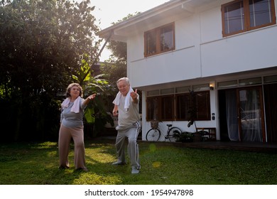 Happy Asian family exercising together at home. Healthy senior couple do outdoor workout exercise yoga tai chi together in the morning. Retirement elderly man and woman enjoy leisure activity at home - Powered by Shutterstock