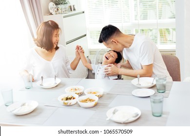 Happy Asian Family Of Father, Mother And Son Playing And Laughing While Having Dinner