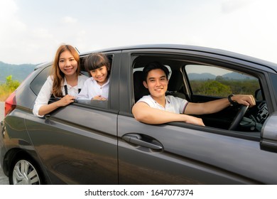 Happy Asian Family With Father, Mother And Daughter In Compact Car Are Smiling And Driving For Travel On Vacation. Car Insurance Or Rental And Family Happy To Journey Concept.