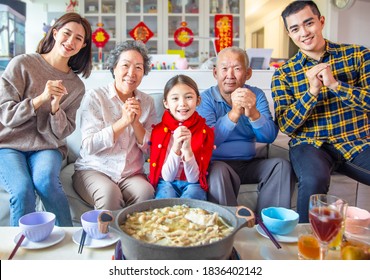 Happy Asian Family Having Dinner And Celebrating Chinese New Year At Home