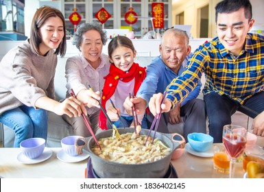 Happy Asian Family Having Dinner And Celebrating Chinese New Year At Home