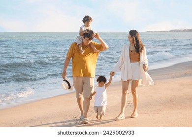 Happy Asian family having fun on the beach together. - Powered by Shutterstock