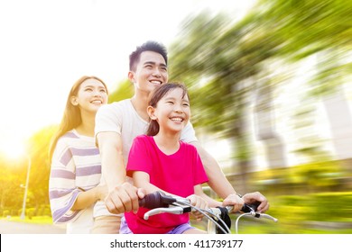 Happy Asian Family Having Fun In Park With Bicycle