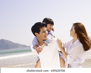 Happy Asian Family Having Fun On Beach.