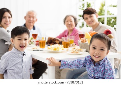 Happy Asian Family Having DinnerÂ at Home