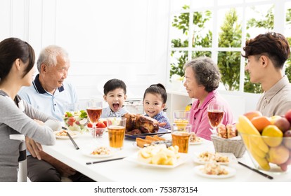 Happy Asian Family Having DinnerÂ at Home