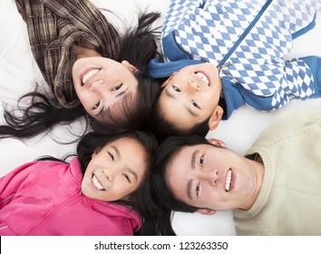 Happy Asian  Family With Heads Together