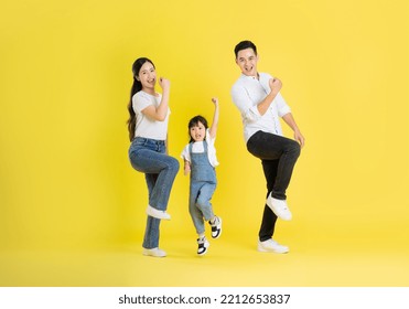 happy asian family image, isolated on yellow background