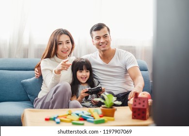 Happy Asian Family Lifestyle Enjoy Playing Game And Watching TV At Home