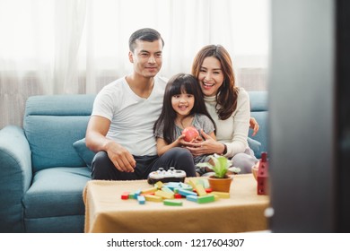 Happy Asian family lifestyle enjoy playing game and watching TV at home
