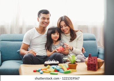 Happy Asian family lifestyle enjoy playing game and watching TV at home