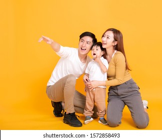 Happy Asian Family Looking Away And Pointing