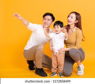 Happy Asian Family Looking Away And Pointing