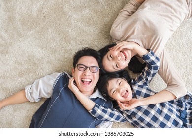 Happy Asian Family Lying With Happy And Smile, Top View