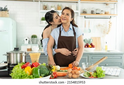 Happy Asian Family Making Salad In Kitchen At Home. Enjoy Family Activity Together.