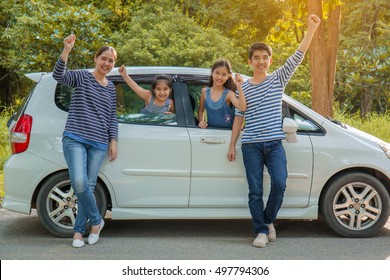 Happy Asian Family With Mini Van Are Smiling And Preparing For Travel On Summer