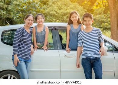 Happy Asian Family With Mini Van Are Smiling And Preparing For Travel On Summer