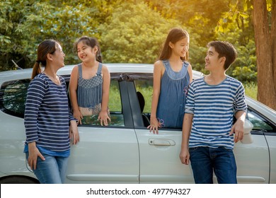 Happy Asian Family With Mini Van Are Smiling And Preparing For Travel On Summer