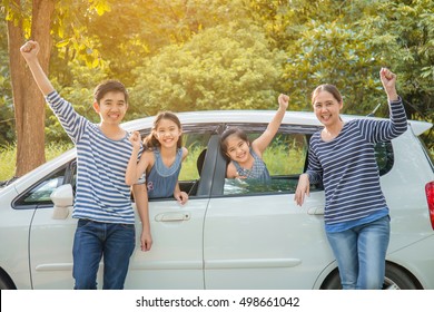 Happy Asian Family With Mini Van Are Smiling And Preparing For Travel On Summer