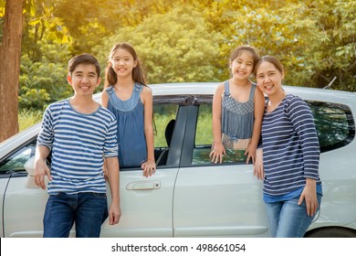 Happy Asian Family With Mini Van Are Smiling And Preparing For Travel On Summer