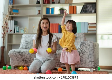 Happy Asian Family Mother And Child Daughter Are Playing Colorful Balls