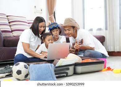Happy Asian Family On A Floor At Home Planning Vacation Travel Trip Togetherness Relaxation Concept