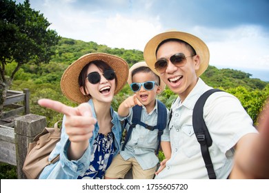 Happy Asian Family On Hiking Adventure And Taking Selfie