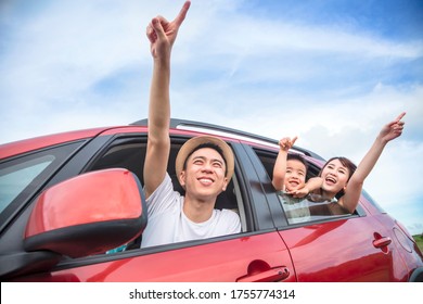 Happy Asian Family On  Road Trip In The Car