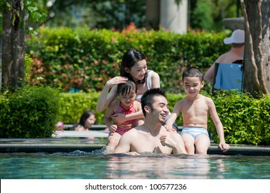 Happy Asian Family Playing In The Pool