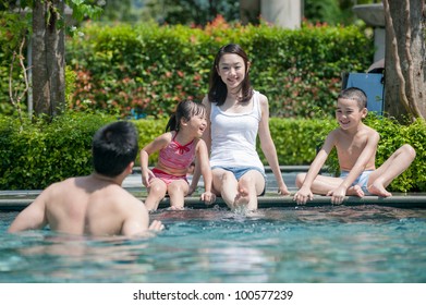 Happy Asian Family Playing In The Pool