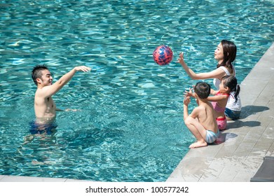 Happy Asian Family Playing In The Pool