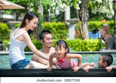 Happy Asian Family Playing In The Pool