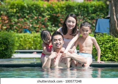 Happy Asian Family Playing In The Pool