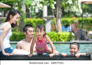 Happy Asian Family Playing In The Pool