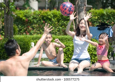 Happy Asian Family Playing In The Pool