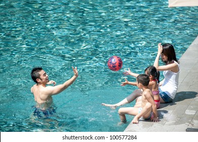 Happy Asian Family Playing In The Pool