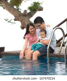 Happy Asian Family Playing In The Pool