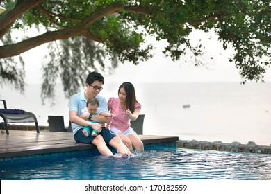 Happy Asian Family Playing In The Pool