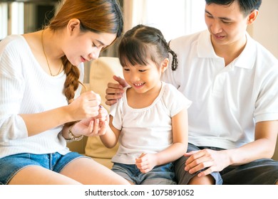 Happy Asian Family Playing In Their Living Room At Hoom 