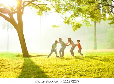 Happy Asian Family Playing Together At Outdoor Park