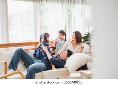 Happy Asian Family Playing Together At Sofa, Home Living Room
