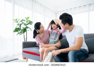 Happy asian family playing together at home in living room